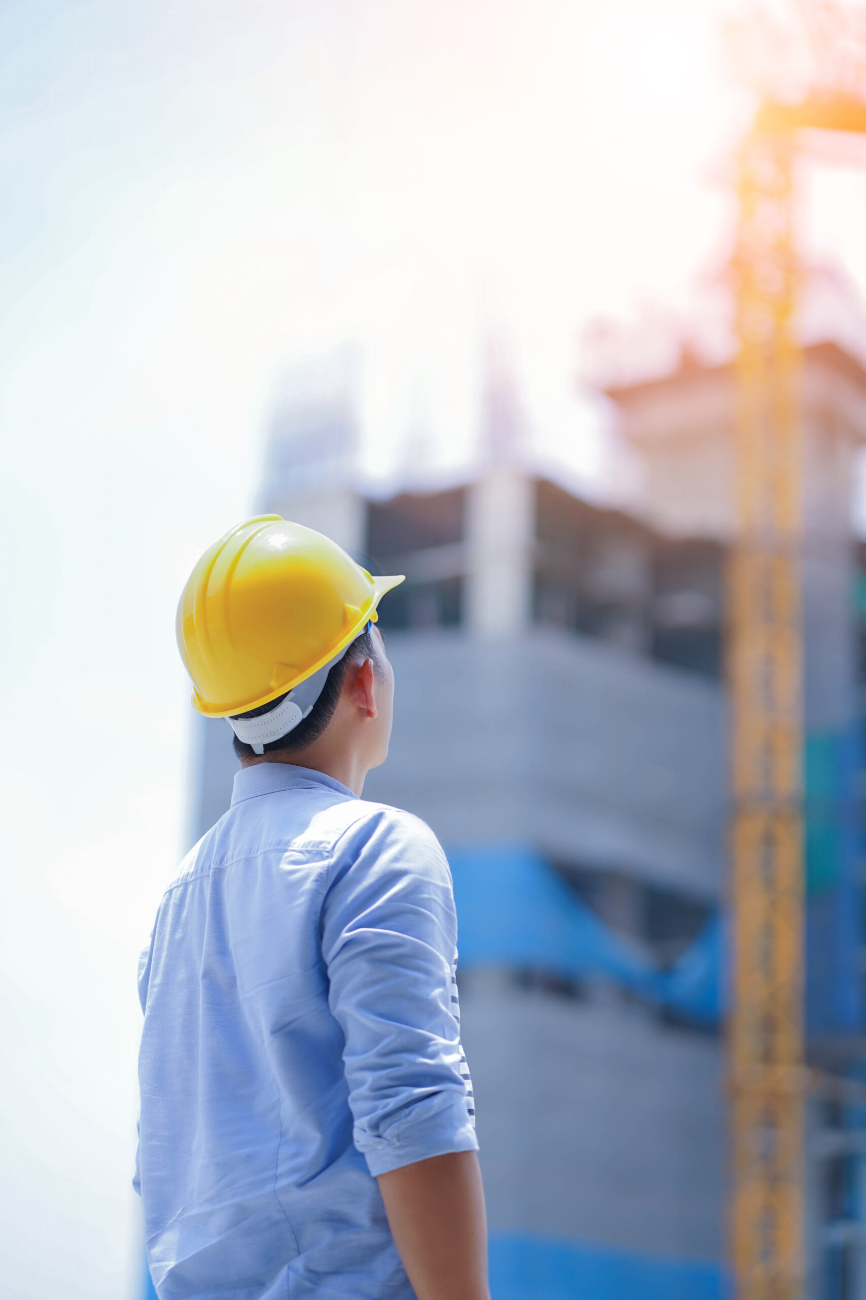 engineer looking a building site and safety helmed.