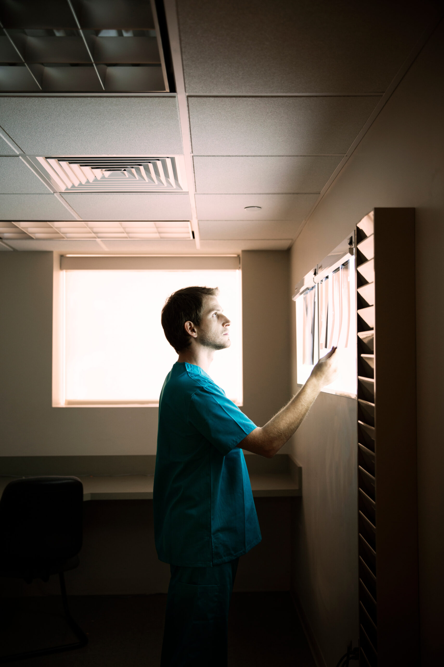 Male doctor examining x-ray images in hospital Male doctor examining x-ray images in hospital