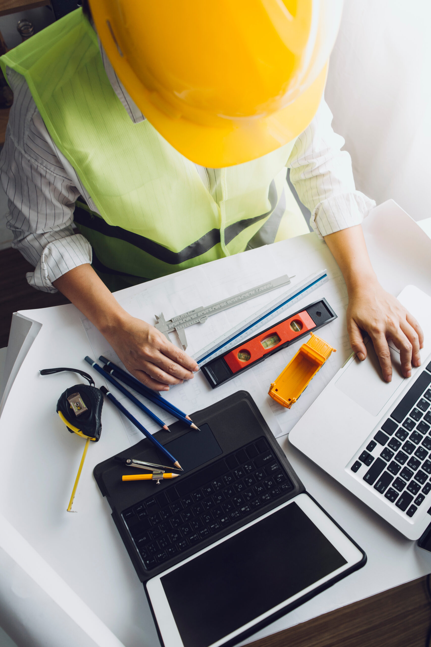 engineer working at a drawings of house in office for discussing engineer working at a drawings of house in office for discussing